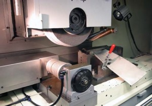 Rotary diamond dresser dresses the grinding wheel, which will profile grind a row 4 turbine blade. The grinding wheel on the Chevalier has 4.75â€ wide capability.